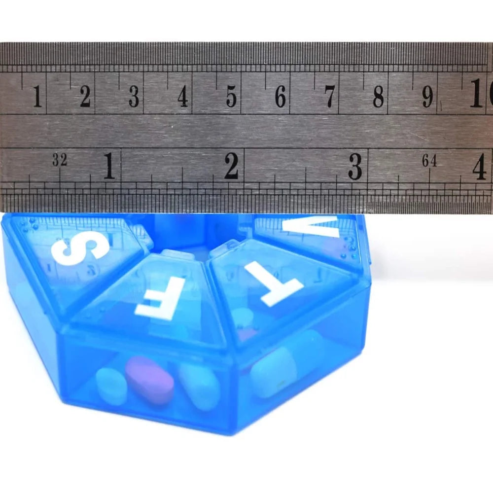 Blue weekly pill organizer with letters on each compartment, measured against a ruler.