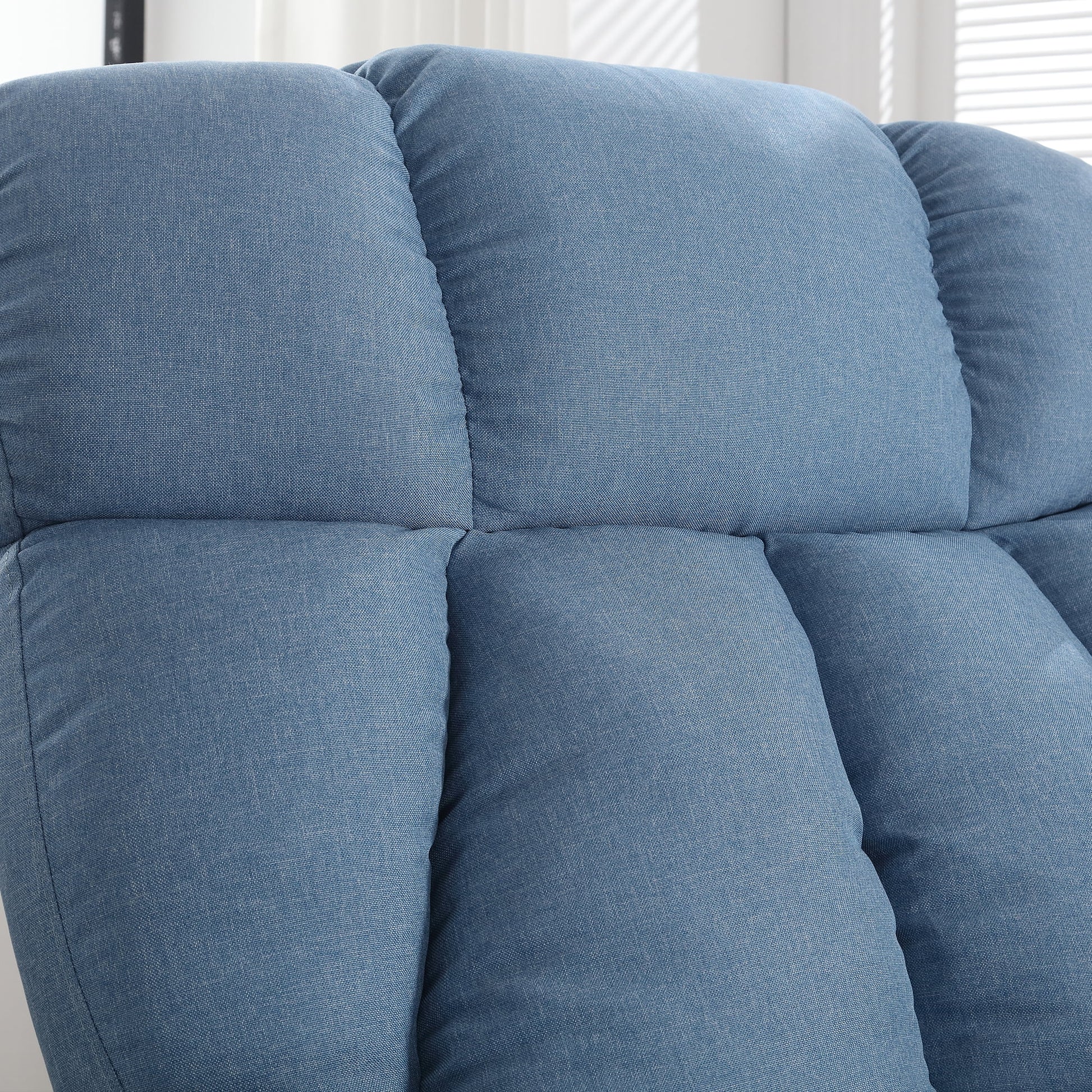 Close-up of a blue upholstered chair with a neutral background