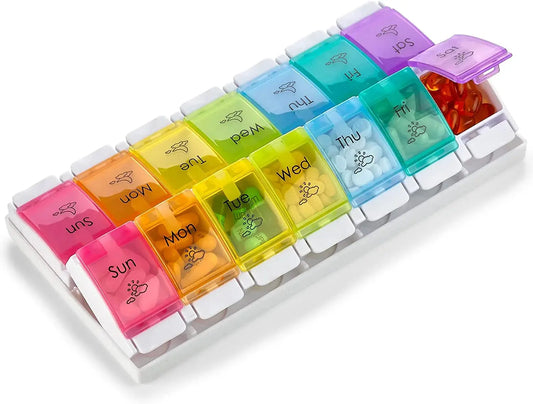 Multicolored weekly pill organizer on a white background