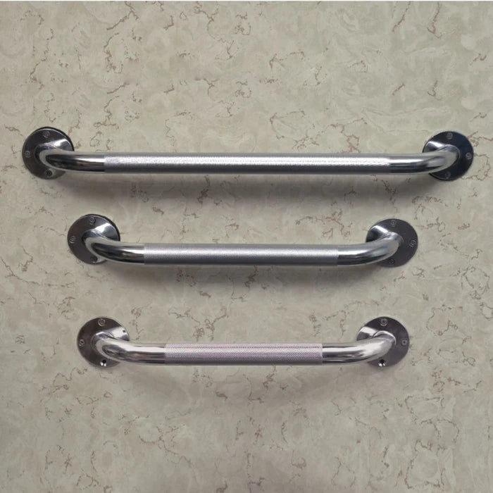 Three chrome metal grab handles with round mounting plates, arranged horizontally on a textured beige wall.