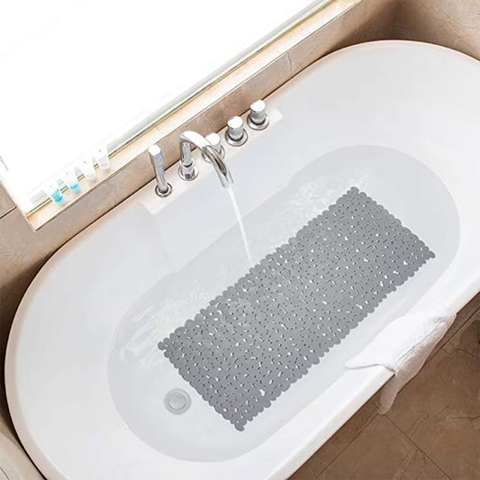 Gray bath mat in a bathtub with running water