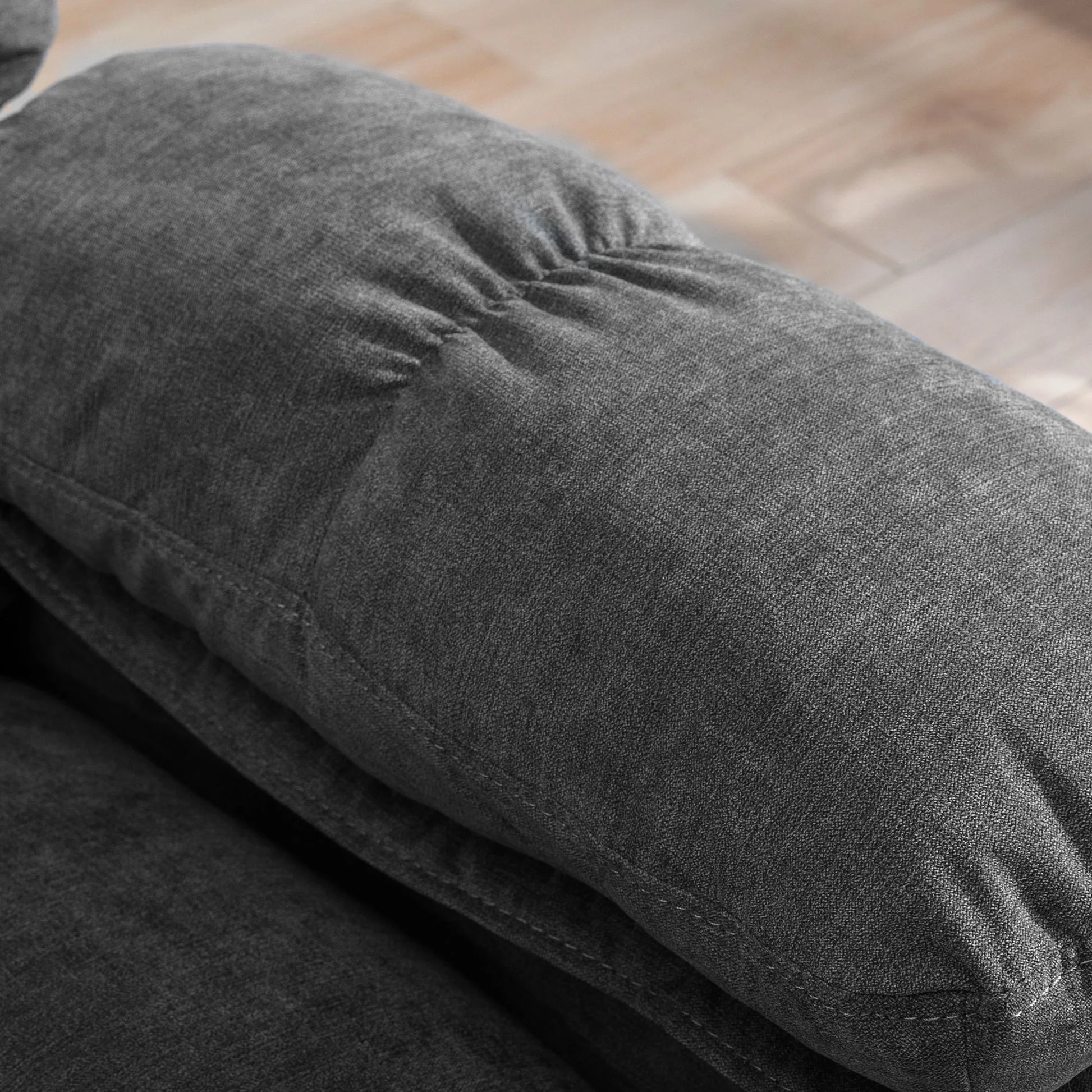 Close-up of dark gray fabric texture on a wooden surface