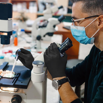 Hands wearing GMG black nitrile gloves. Ideal for medical exams, food prep, and cleaning tasks.