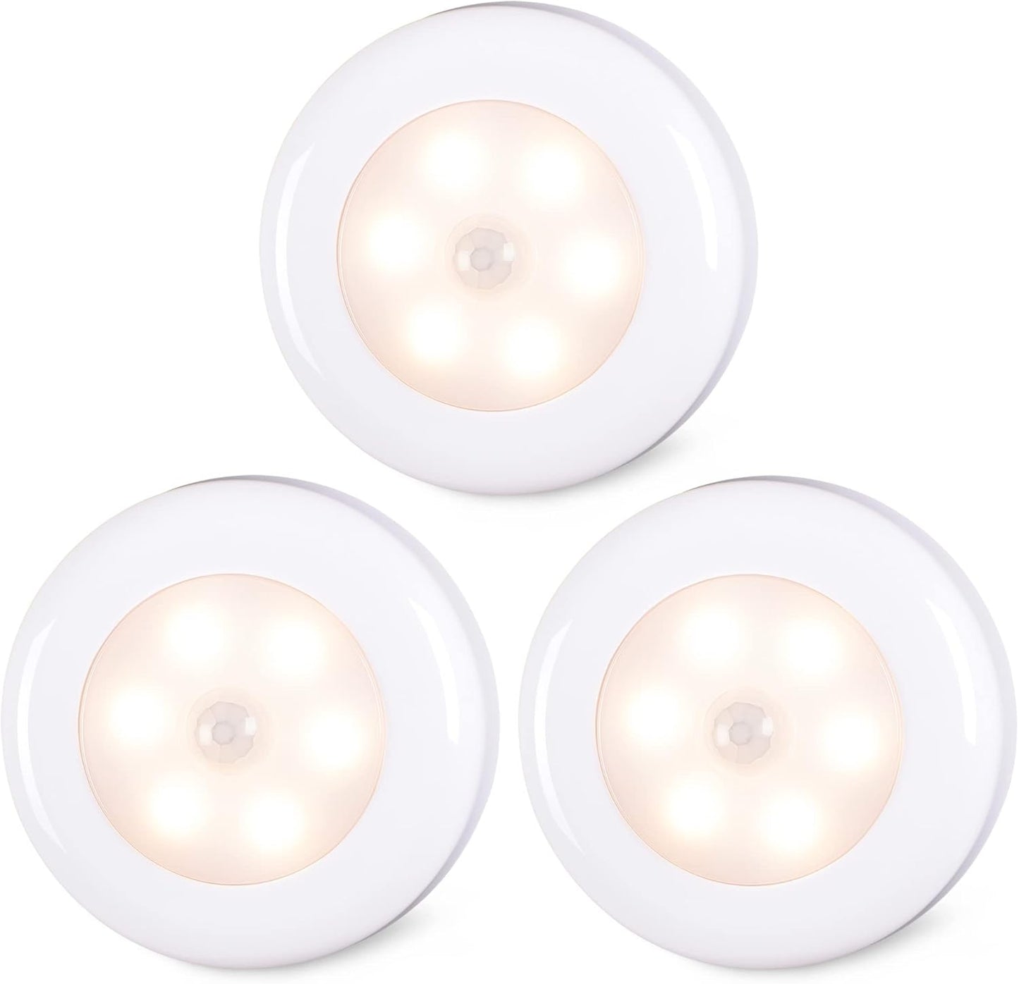 Three white round night lights with a warm glow on a white background

