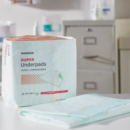 Box of McKesson Super Underpads on a surface with a blurred background