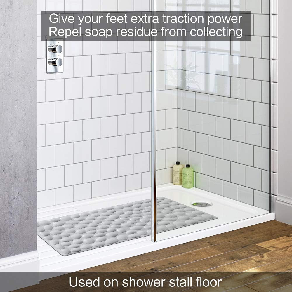 Shower stall with a textured mat on the floor, featuring text about extra traction power and soap residue repel.