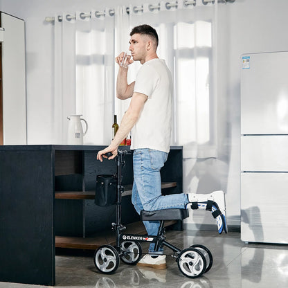 Man using a knee walker in a modern kitchen.

