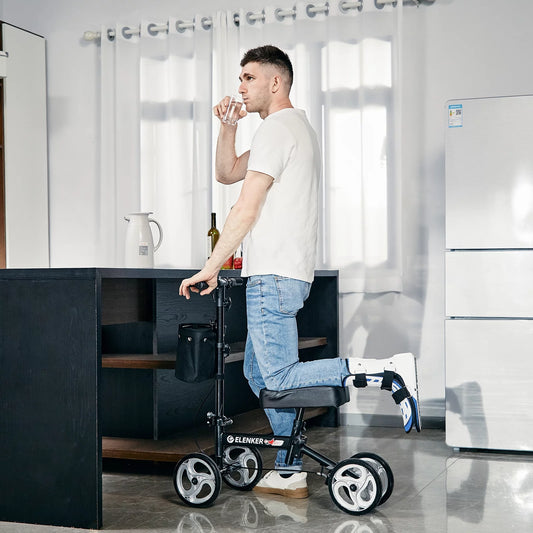 Man using a knee walker in a modern kitchen.

