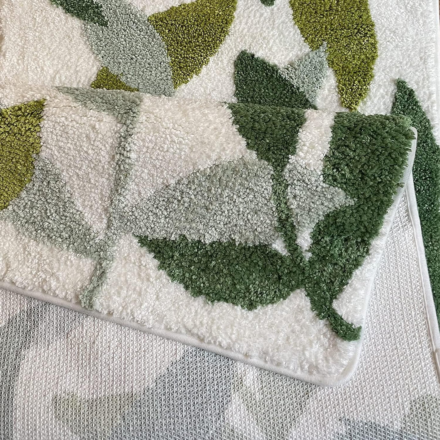 Textured green and white fabric with leaf patterns

