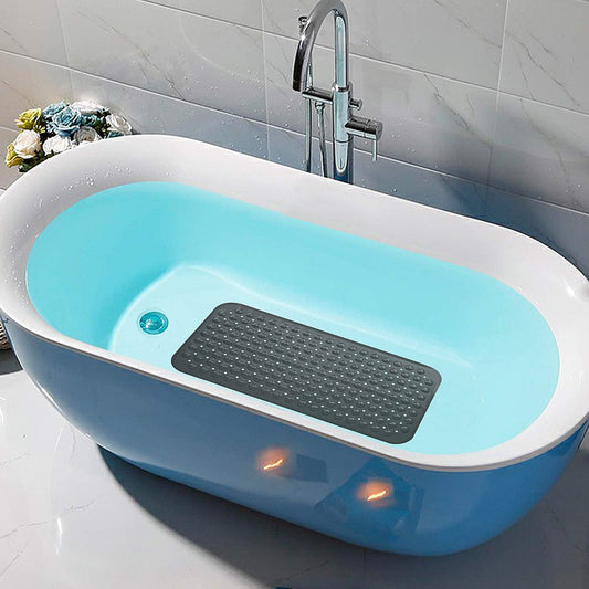 Blue bathtub with a black mat inside, placed on a tiled bathroom floor.

