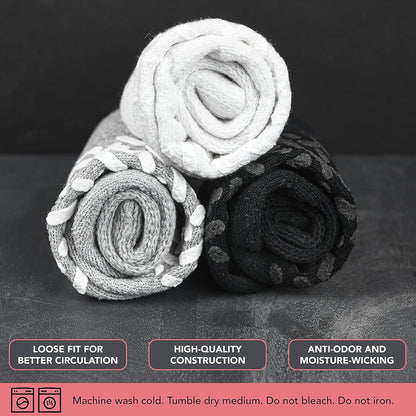 Three rolled-up socks on a dark surface with text about sock features.