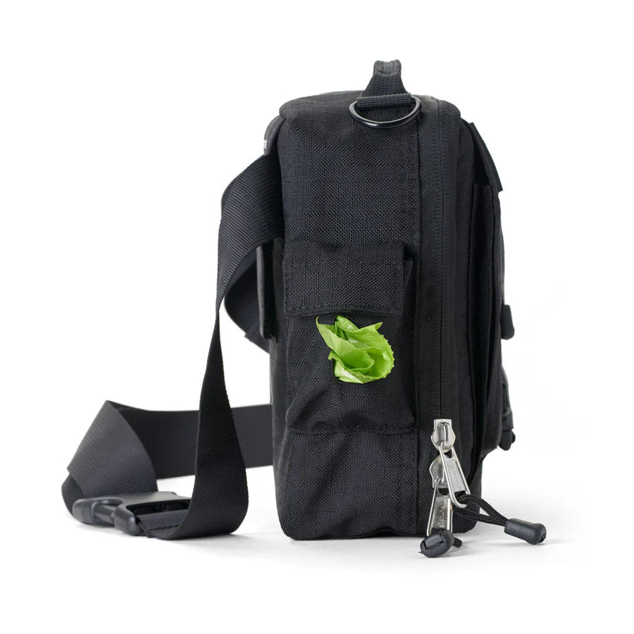 Black sling bag with a green leaf on a white background


