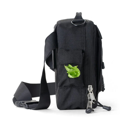 Black sling bag with a green leaf on a white background

