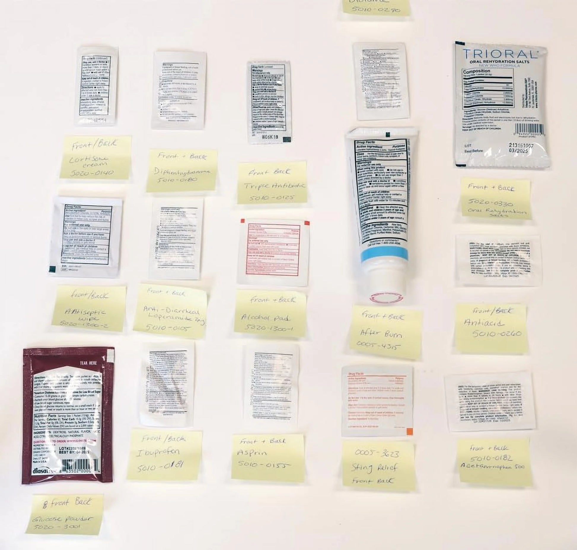 Collection of medical packets and a tube on a white background

