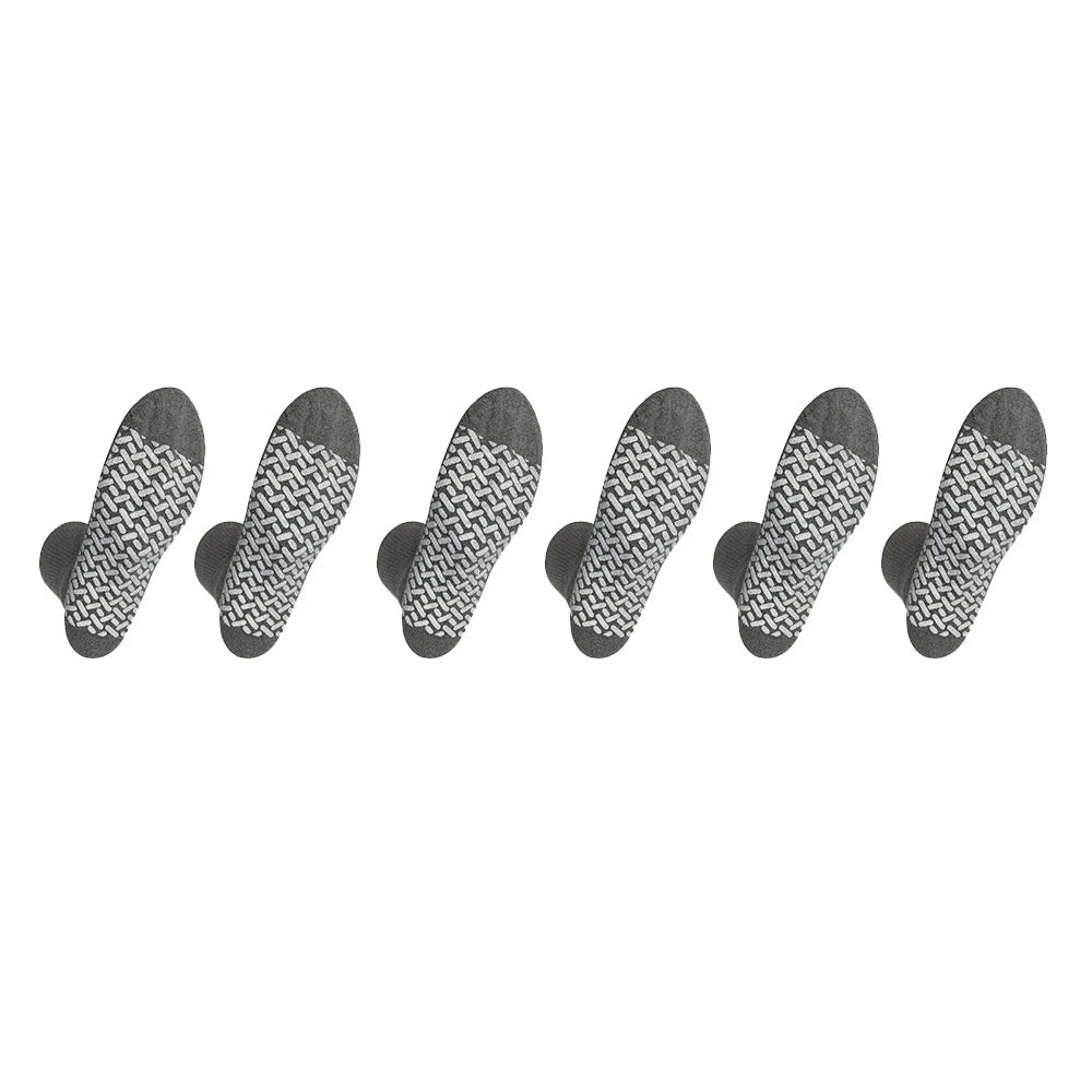 Set of seven black and white patterned socks arranged in a row on a white background