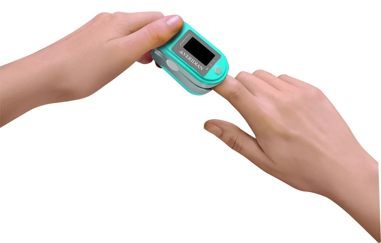 Finger pulse oximeter being used on a finger with a white background

