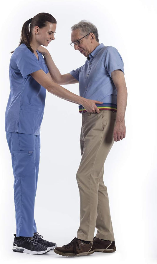Two people in blue scrubs standing close together on a white background
