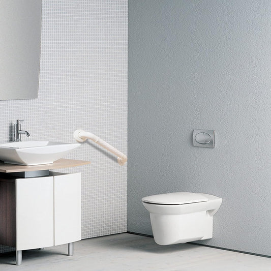 Modern bathroom with a toilet and sink against a gray wall.