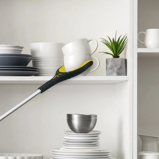 User retrieving items with Royal Medical grabber tool. Ideal for seniors and limited mobility.