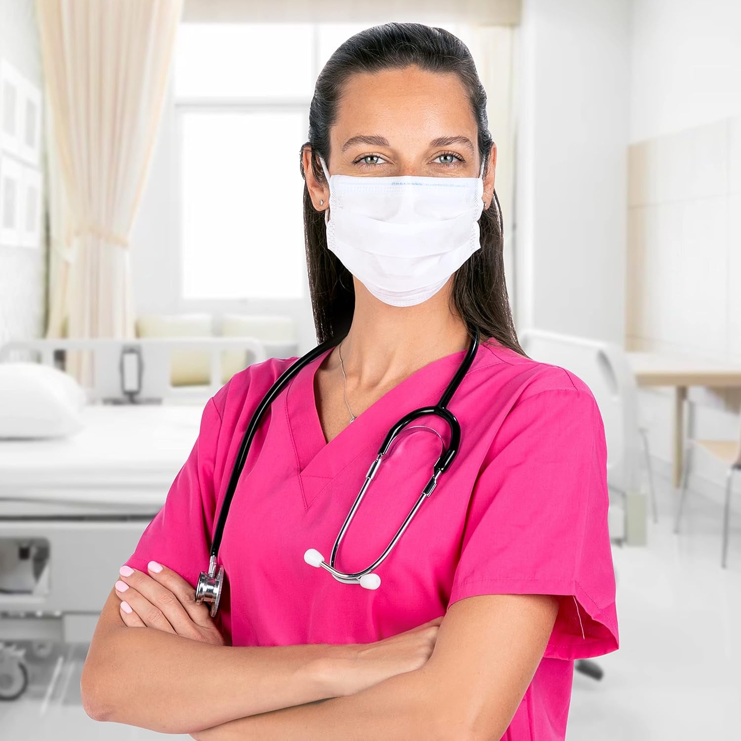 Nurse in pink scrubs with a stethoscope and face mask in a hospital setting