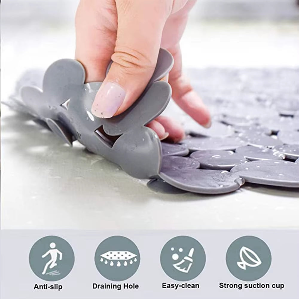 Gray silicone mat with suction cup being held by a hand, featuring icons for anti-slip, draining hole, easy-clean, and strong suction cup.