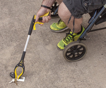 User retrieving items with Royal Medical grabber tool. Ideal for seniors and limited mobility.