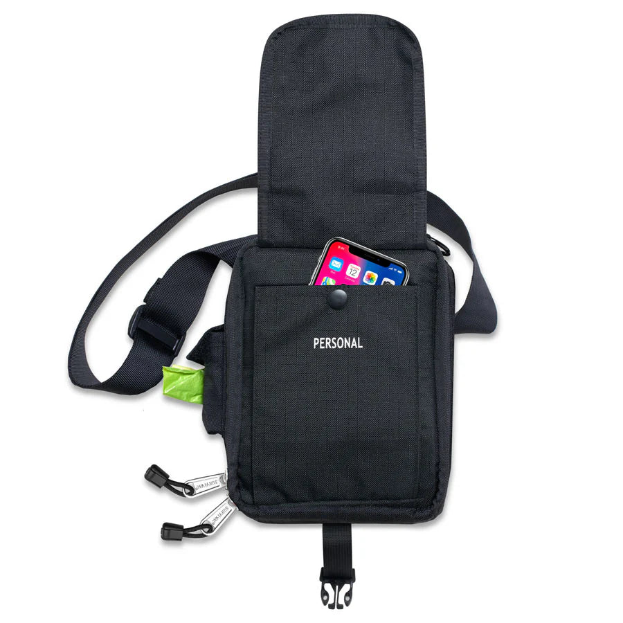 Black crossbody bag with a pocket holding a smartphone and other items on a white background

