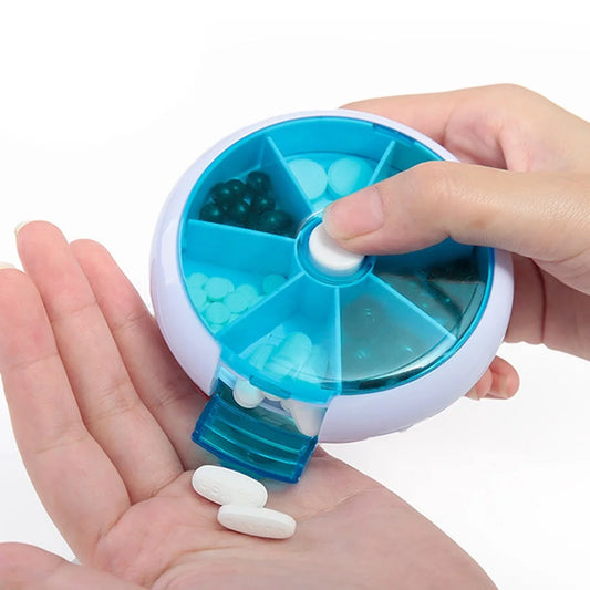 Blue and white pill organizer with compartments being used to dispense pills.