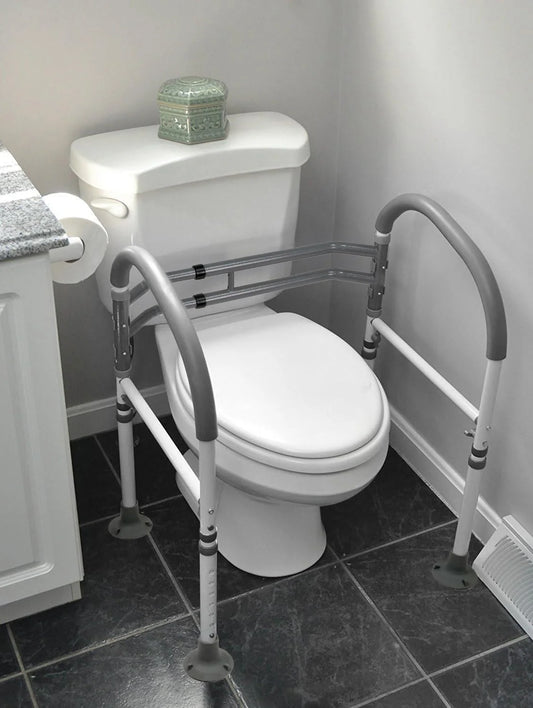 Vaunn toilet safety rails installed on standard toilet. Provides stable support for elderly, disabled, and post-surgery users.