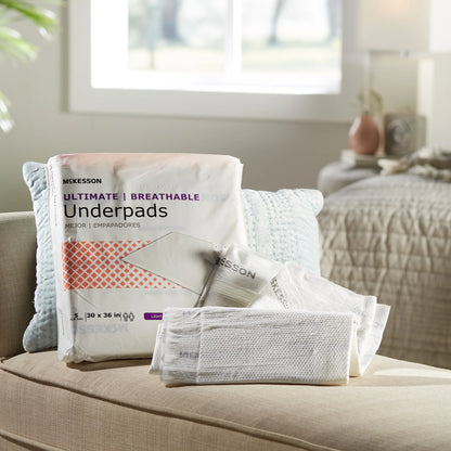 McKesson underpads packaging on a couch in a home setting