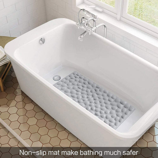 White bathtub with a gray non-slip mat in a bathroom setting