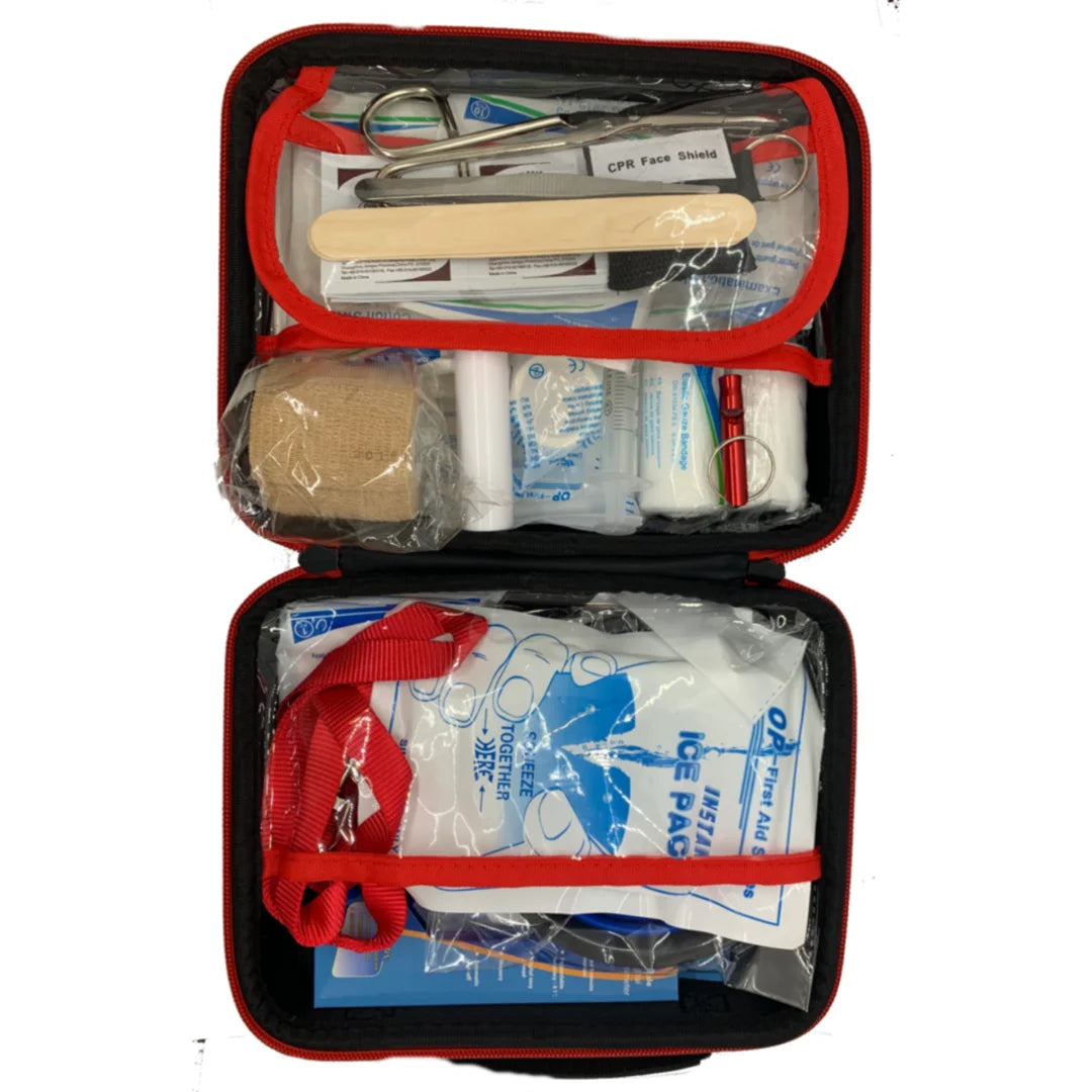 First aid kit with various supplies in an open red case on a white background