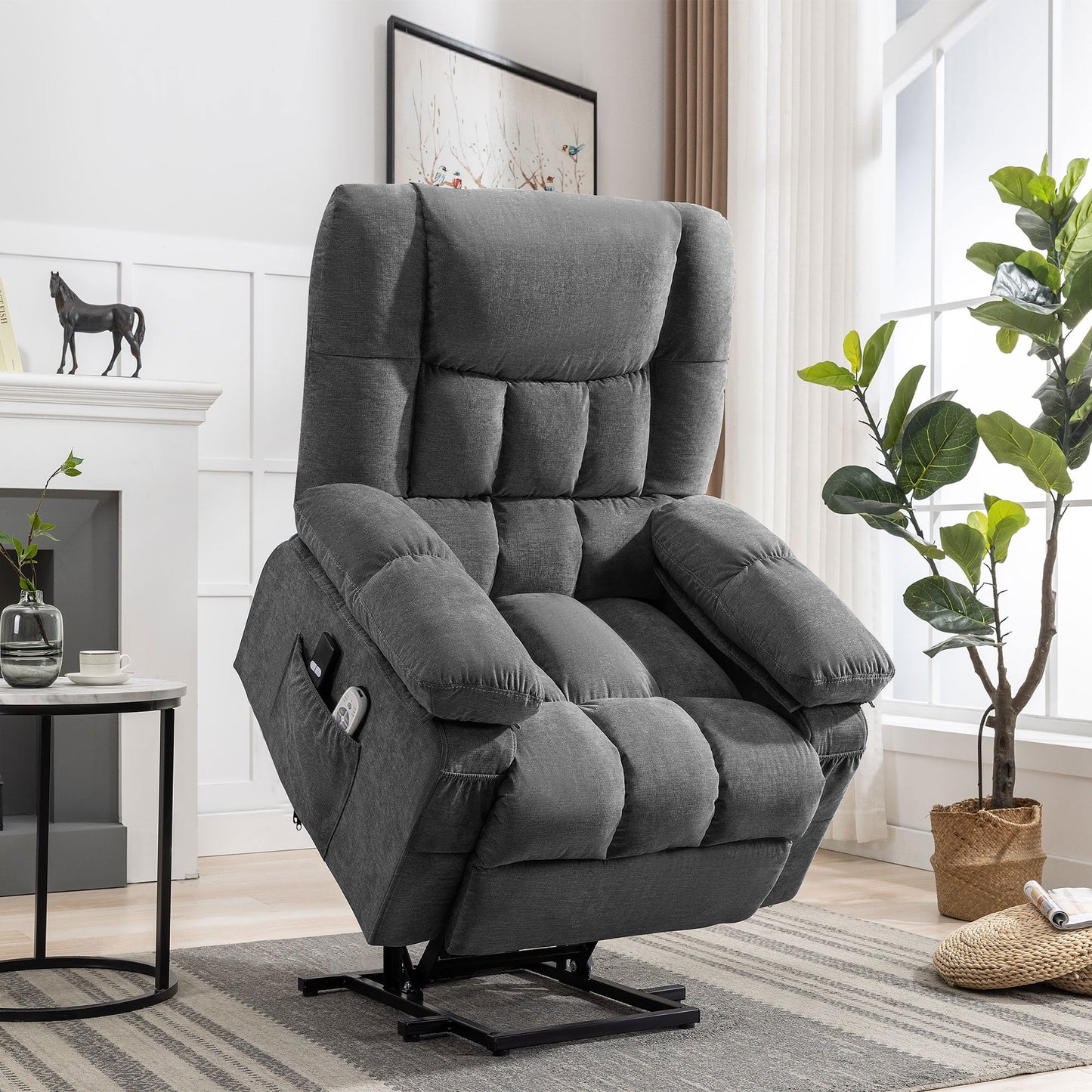 Gray recliner chair in a living room setting with a fireplace and plants.