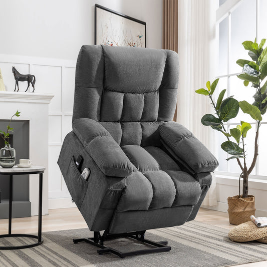 Gray recliner chair in a living room setting with a fireplace and plants.