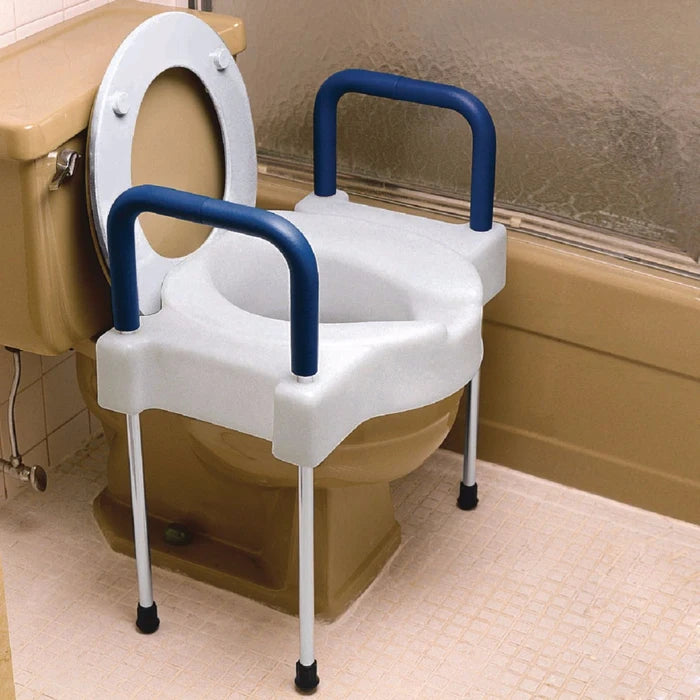 Bathroom commode with blue handles and white seat on a beige toilet.