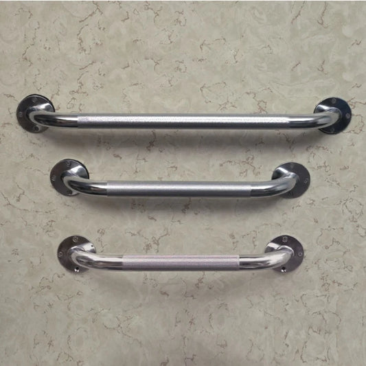 Three chrome metal grab handles with round mounting plates, arranged horizontally on a textured beige wall.