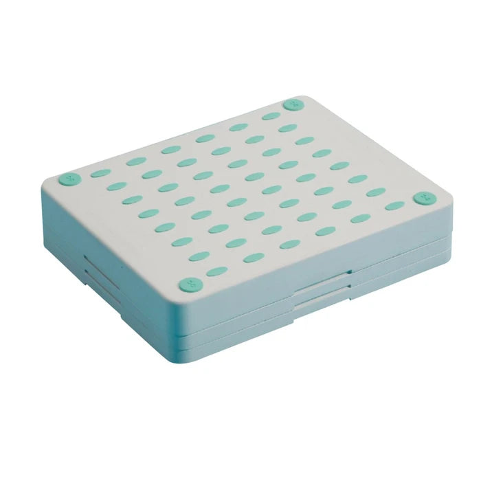 Rectangular plastic step with green circular holes on a white background