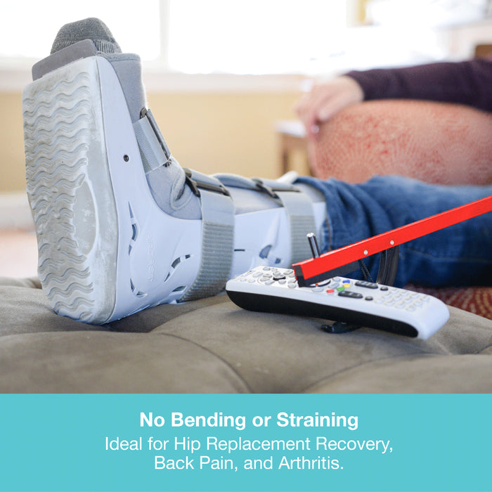 A person reclining with a white and gray leg cast/boot on their leg, with a remote control nearby and a teal text banner at the bottom reading 'No Bending or Straining Ideal for Hip Replacement Recovery, Back Pain, and Arthritis.'.