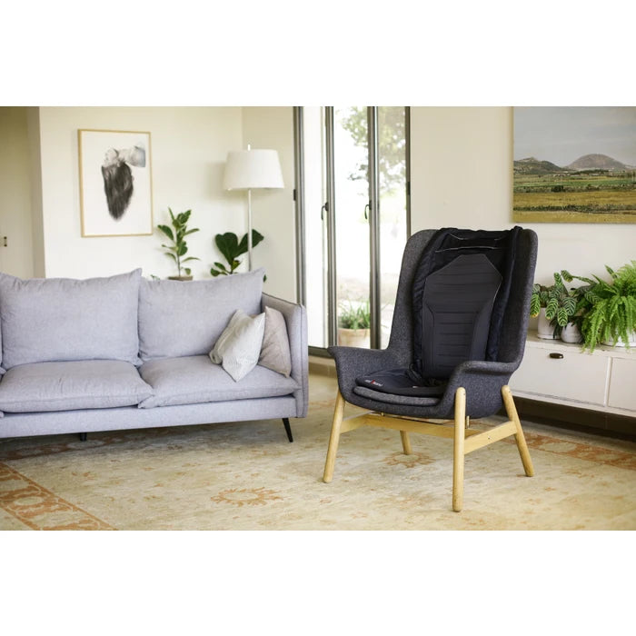 Modern living room with a gray sofa and a black armchair.