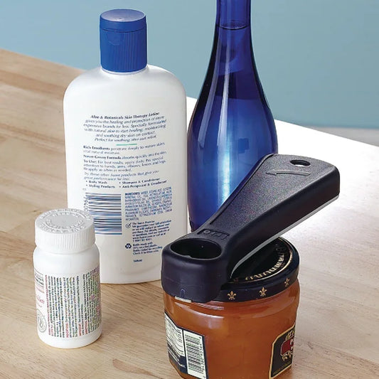 Canning opener on a table with various items including a bottle, jar, and lotion.