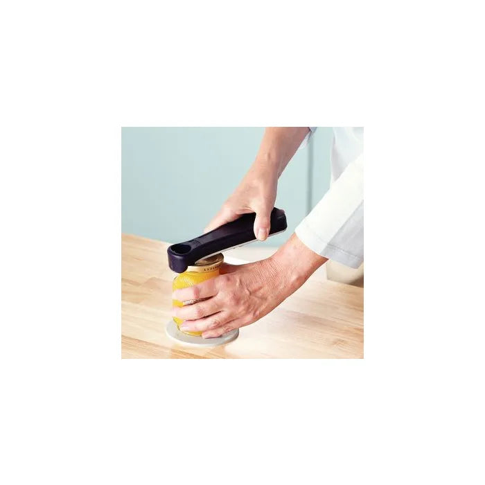 Person using a jar opener on a jar with a white background