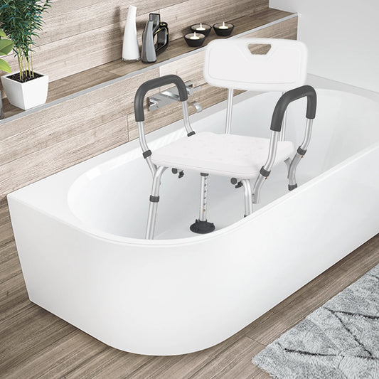 Bath tub with a shower seat and grab bars in a bathroom setting.

