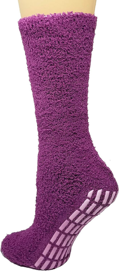 Purple fuzzy sock with non-slip sole on a neutral background