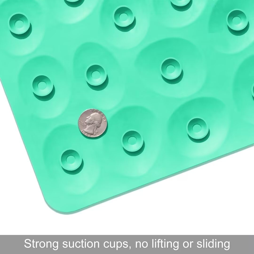 Green silicone mat with suction cups and a coin for size reference on a white background