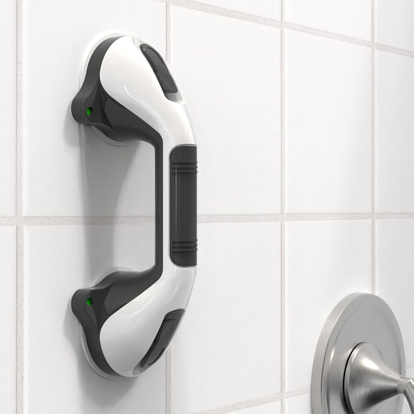 White and black grab bar mounted on a tiled bathroom wall.