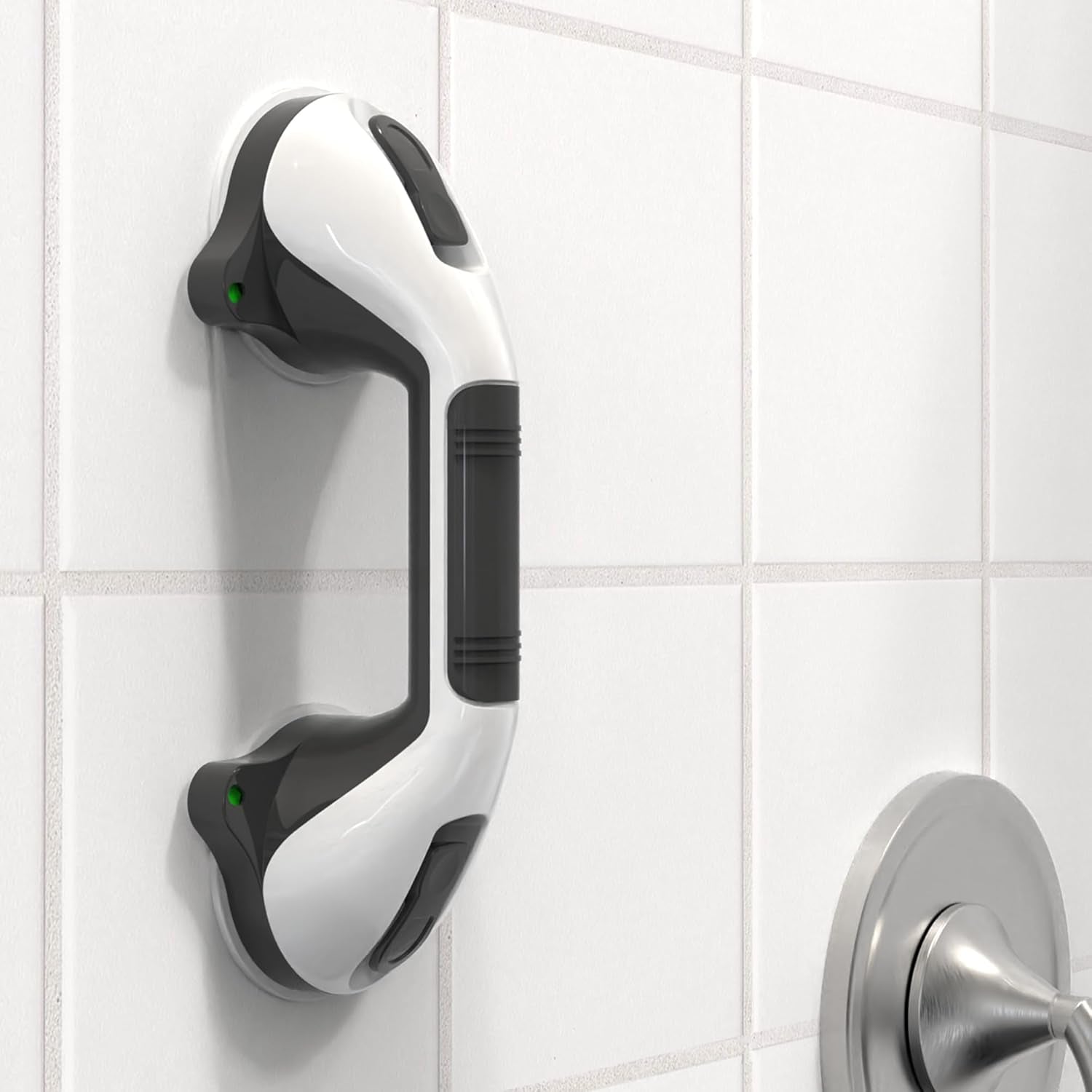 White and black grab bar mounted on a tiled bathroom wall.