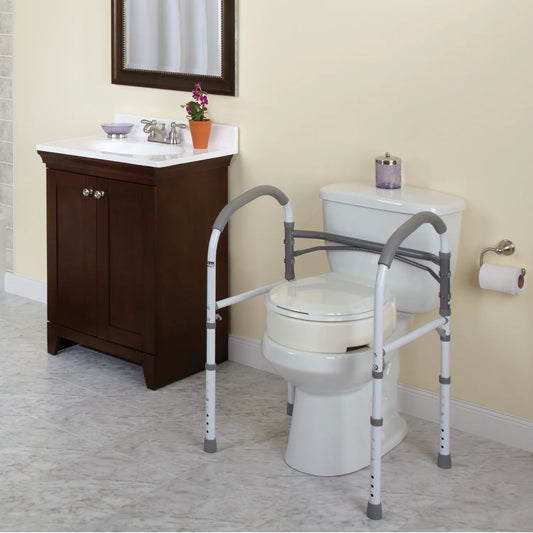 Carex toilet safety rails installed around a standard toilet. Provides safe, supportive access for elderly and mobility-impaired users.