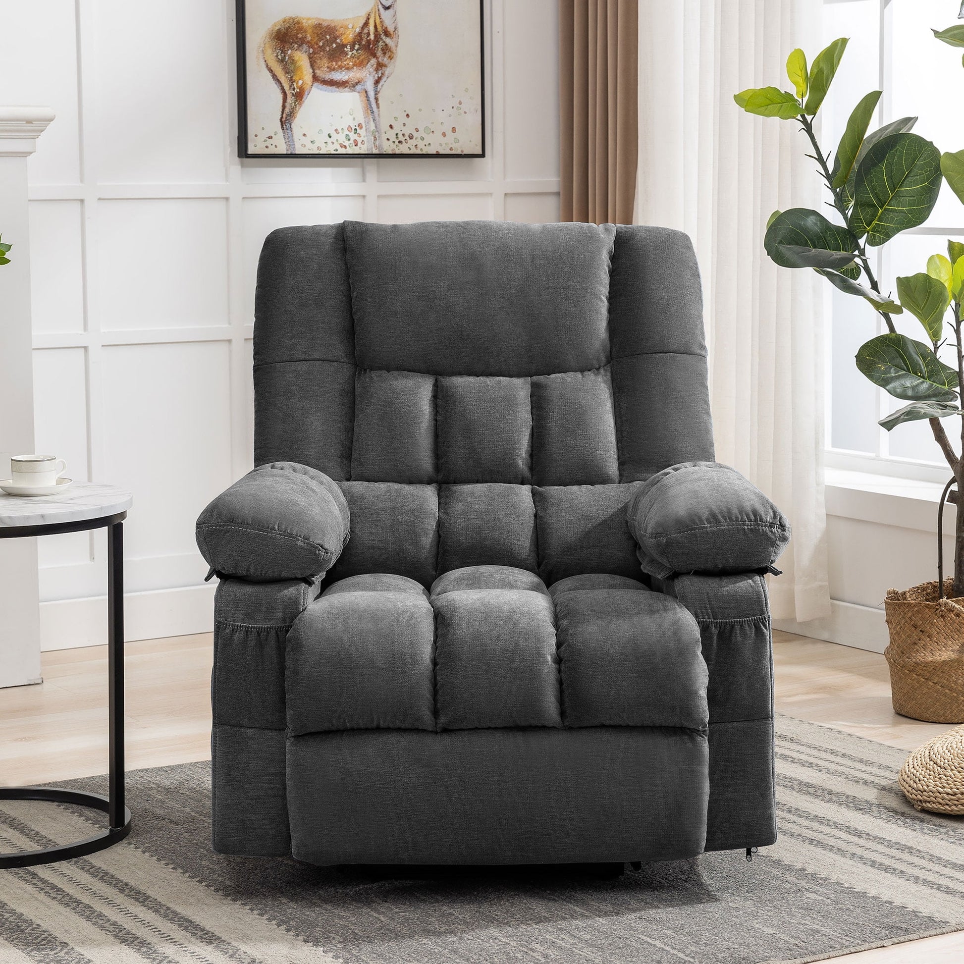 Gray recliner chair in a living room setting with a plant and side table.