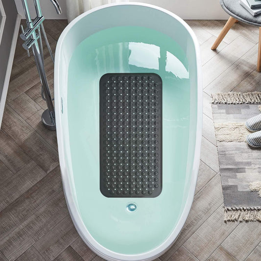 Light blue bathtub with a black textured mat inside on a wooden floor.

