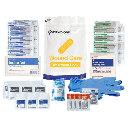 First aid kit with various components including a wound care treatment pack, trauma pad, and gloves on a white background.
